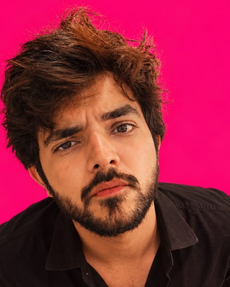 Gaurav, co-founder of editNad, against a pink background